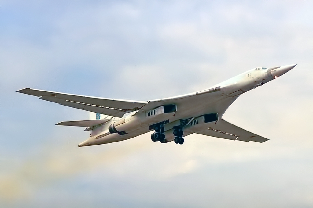 Two Tu-160 Blackjack bombers flying in formation showing the distinctive white paint scheme
