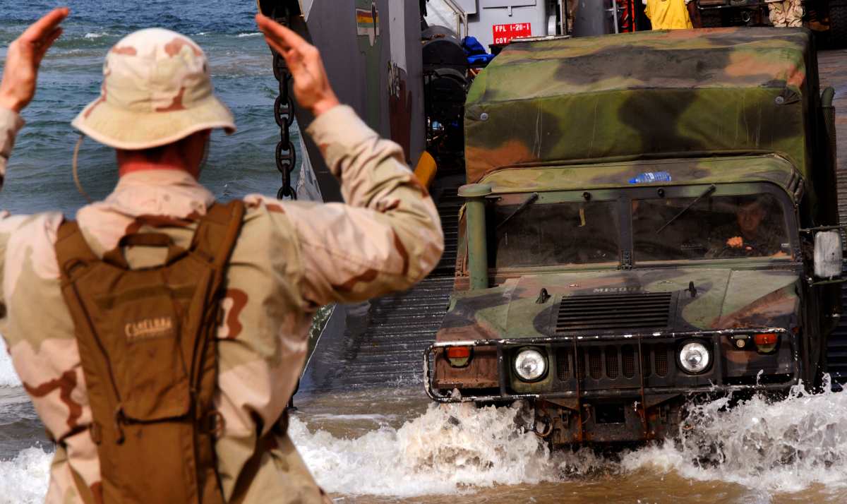 a Humvee as it disembarks from Landing Craft Unit 1660, assigned to Assault Craft Unit 2, during an offload of U.S, Spanish, Portuguese and British Marines from the embarked Security Cooperation Marine Air-Ground Task Force and Seabees assigned to Naval Mobile Construction Battalion 7. 