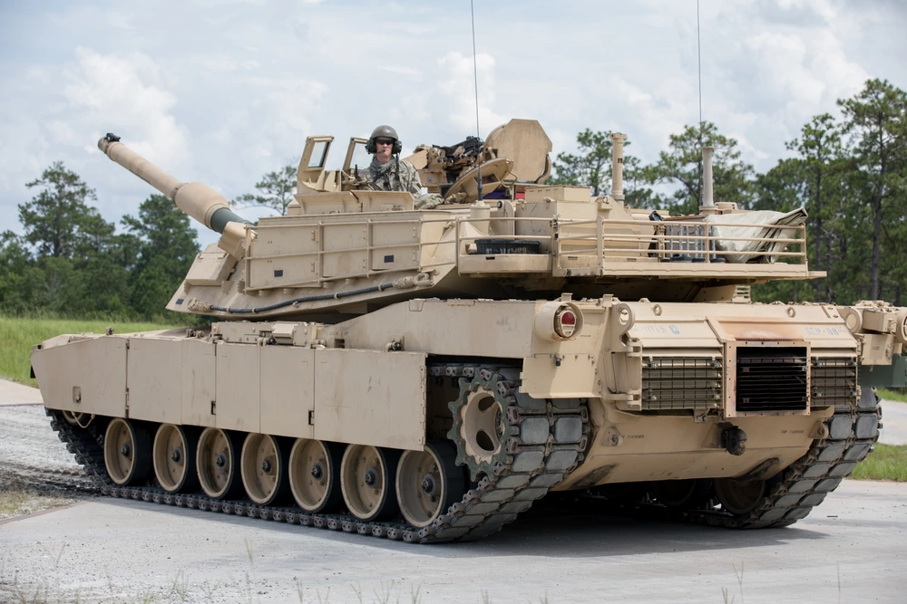 M1A2 Abrams tank firing during live fire exercise demonstrating modern armored tactics